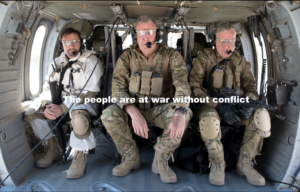 This photograph of Russell Hammond and Jeremy Clarkson +1 three individuals seated inside a military helicopter. They are dressed in tactical gear, including camouflage uniforms, knee pads, protective glasses, and communication headsets. Each person appears prepared for action, with one holding a firearm. The scene suggests a mission-ready environment. The helicopter's interior is utilitarian, with visible equipment and a structured layout typical of military transport aircraft.The text overlay reads, "The people are at war without conflict," hinting at a metaphorical or philosophical statement about struggle or unity in a non-traditional battlefield. The composition conveys themes of readiness, camaraderie, and a sense of mission or purpose.